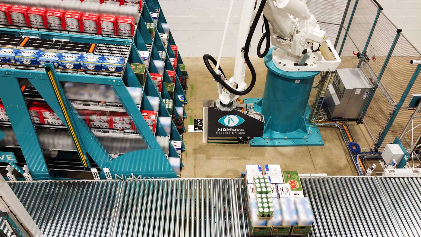 RAPTOR (Robot Arm Picking to Order Release) from NūMove Robotics & Vision and KPI Solutions combines AI-driven 3D vision, adaptive dual-robot technology, advanced cubing software and Opto WES’s integration to automate depalletizing and mixed-SKU palletizing. This synergy delivers real-time order orchestration, dynamic SKU handling and unmatched flexibility, transforming one of the most labor-intensive processes in beverage distribution. The process begins with robotic depalletizing, where a high-speed robot equipped with proprietary 3D vision and AI algorithms identifies and localizes individual products on donor pallets, even when packaging graphics change. Products are then organized by SKU into dedicated buffer lanes within a flow rack. On the opposite side of the buffer flow rack, a second robot performs robotic palletizing, retrieving items one at a time to build dense, stable mixed-SKU pallets. Advanced cubing software determines optimal pallet layout, applying stacking rules for product type, size and weight to meet store requirements. NūMove Robotics & Vision, numovegroup.com, Booth C14198