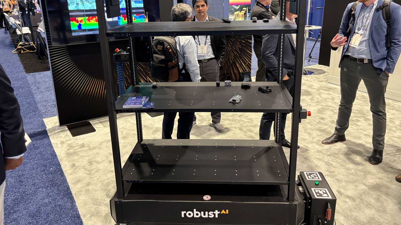 The Aptiv booth, featuring Robust.AI and Wind River, showcasing the companies' integrations in the software and cobot space.