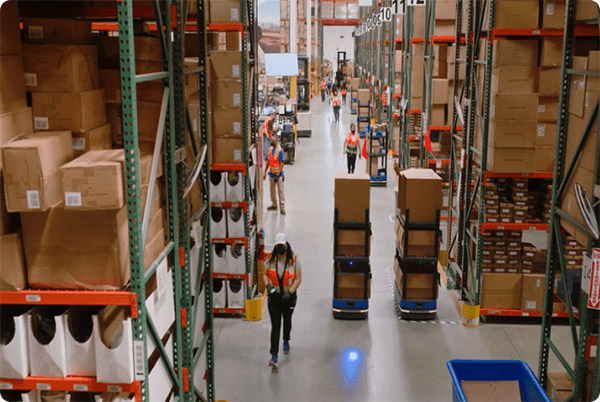 6 River Systems' Chuck mobile robots work with associates in warehouses.