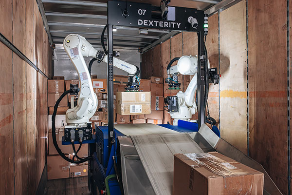 The Dexterity DexR is an AI-enabled robot with two robot arms that precisely build walls in a truck.