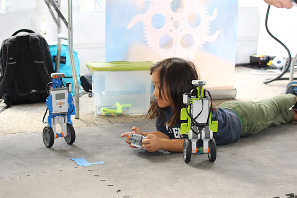 Girl and robot at RoboBoston
