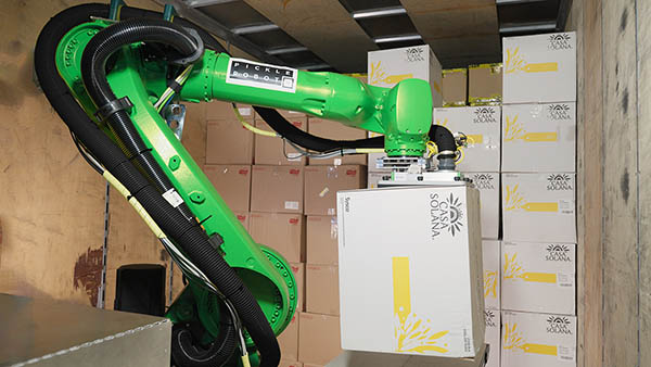 Pickle Robot placing large box on onboad conveyor