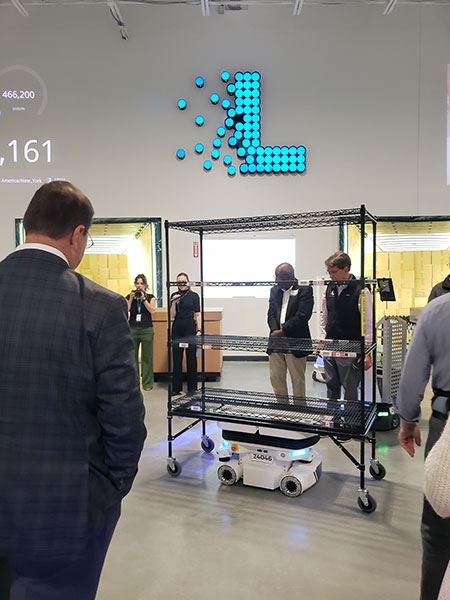 The Vector omnidirectional deck-lifting AMR is designed to handle heavier and/or bulkier objects. This Vector robot is moving an empty shelf cart to a drop off point.
