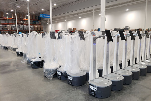 One corner of the new Locus warehouse is packed with robots waiting to be distributed. A large number of them are being deployed for peak retail and e-commerce season.