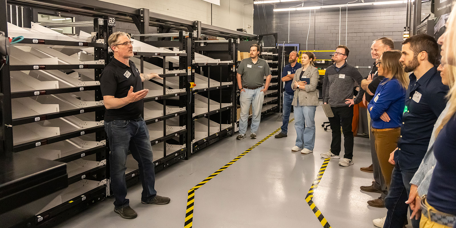 At the last stop on the tour, TA explains how BG’s Robotic Shuttle Put Wall (RSPW) can sort items for e-commerce order consolidation and reverse logistics.

 

Photo by Donald Halsing | Peerless Media
