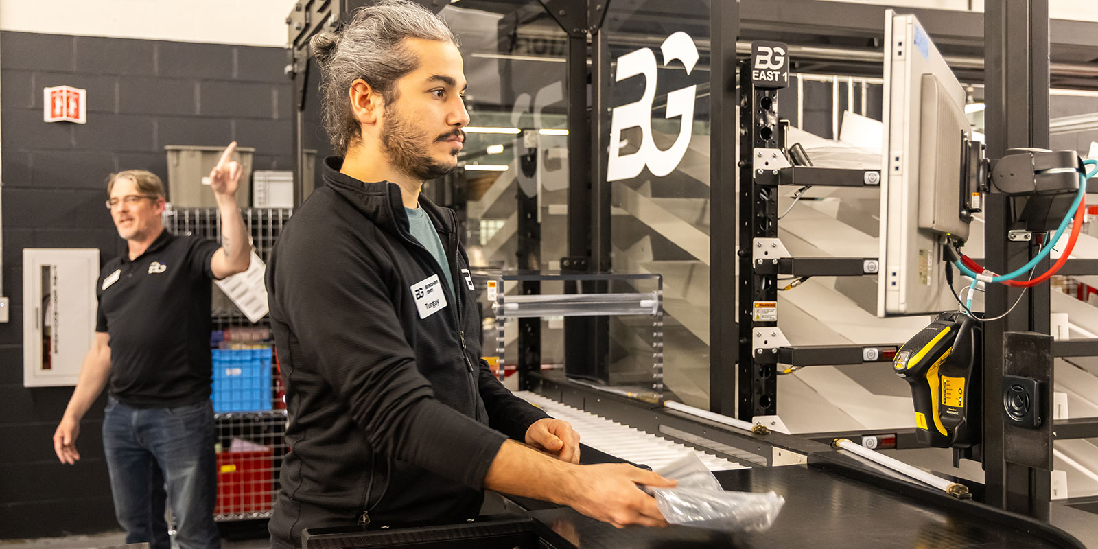 Turgay Tekin, Berkshire Grey software quality engineer, scans items for placement into the put wall.

 

Photo by Donald Halsing | Peerless Media