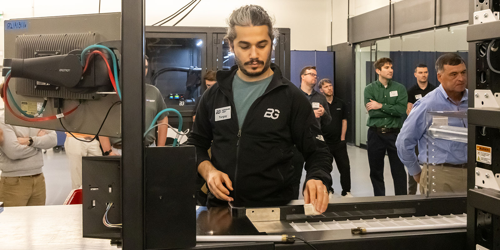 Tekin places an item onto a conveyor for induction into the put wall. 

 

Photo by Donald Halsing | Peerless Media