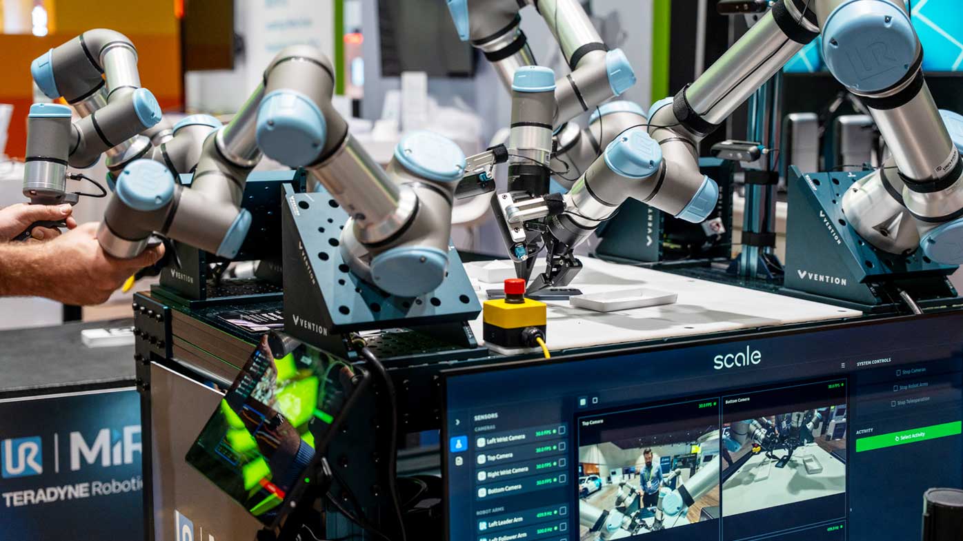 Universal Robots (UR) is showcasing the UR AI Trainer, an  imitation learning platform developed in collaboration with Scale AI. Traditionally, AI robotics training has been hindered by a significant "lab-to-factory" gap. Researchers often depend on fragmented hardware or fragile research arms that are not suited for production environments, while many systems rely solely on visual feedback. The UR AI Trainer directly addresses these barriers by providing a standardized, industrial-grade foundation for capturing high-fidelity, force-aware data on the very same robots intended for final deployment. An Automate demo allows users to physically guide a "leader" UR3e robot through an advanced smartphone packaging task, and the operator provides real-time haptic input to a "follower" UR7e robot that mirrors the motion in real time. This process does more than just mirror motion; it utilizes UR's unique Direct Torque Control and force feedback to give developers direct influence over how the robot physically interacts with the world. Universal Robots, universal-robots.com, Booth 1250