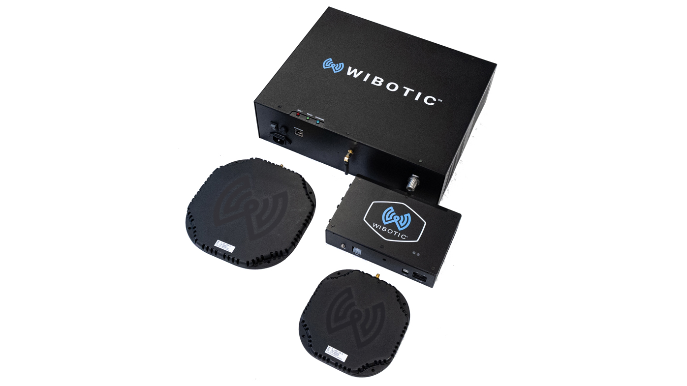 The WiBotic 1 kW system is built around the TR-1000 transmitter and OC-1000 onboard smart charger, providing up to 1000 watts of wireless power transfer. The transmitter supports 100 to 230V AC input at up to 20A and converts facility power into a high frequency wireless signal, while the OC-1000 delivers up to 36A of charging current across a 12.0 to 58.4V DC battery range. Designed for flexibility, the 1 kW platform supports a wide range of battery chemistries including LiIon, LiFePO4, LiPo, Lead Acid, SLA, NiMH and NiCad. Charge rate and battery voltage parameters are configurable in software, allowing mixed fleets with different battery types to share common charging infrastructure. Ethernet connectivity at the transmitter and UAVCAN API over CANBus on the vehicle enable integration with robot scheduling and fleet management systems, helping operators optimize charge cycles, extend battery life and reduce manual oversight. WiBotic, wibotic.com, Booth C15598
