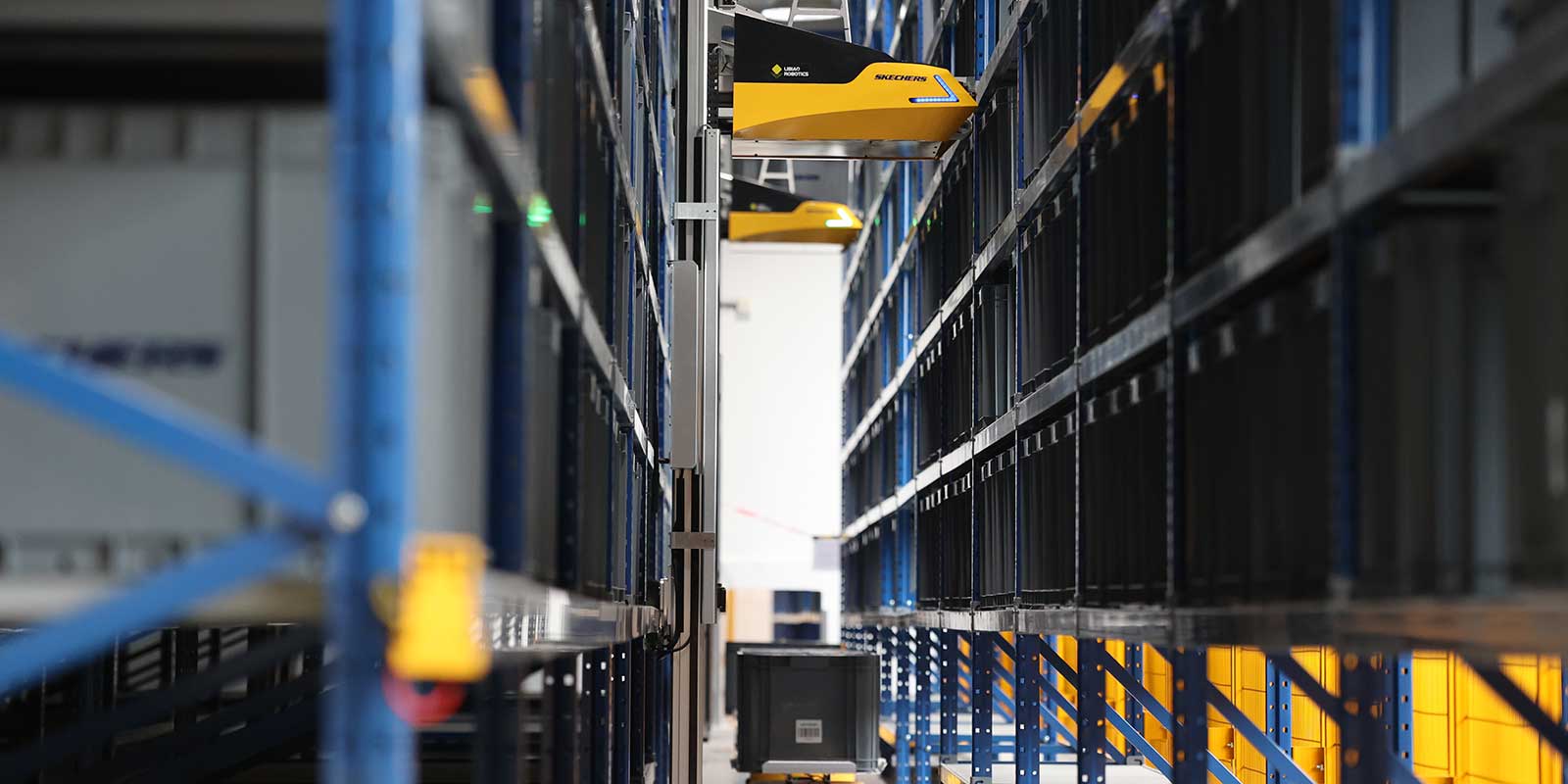 Libiao Robotics’ AirRob system challenges how businesses approach storage, organization and order fulfillment. AirRob’s design minimizes infrastructure needs, requiring little more than basic racks and floors to deploy. The system operates within a wide temperature range of -20 to 50°C, offering versatility across various environments. AirRob was built to handle organizational traffic with precision and speed. The system utilizes twin-directional picking, which optimizes space utilization by simultaneously serving both the front and back racks. With aisle widths as narrow as 0.85 meters, AirRob ensures maximum space efficiency, allowing businesses to store more while maintaining smooth and quick access to inventory. The AirRob system can handle 20,000 totes per hour, and its scalability means businesses can easily expand their operations by adding additional AirRob units per aisle or pairing it with multiple floor bots to facilitate tote handovers at any location under the rack. Libiao Robotics, Booth E12030